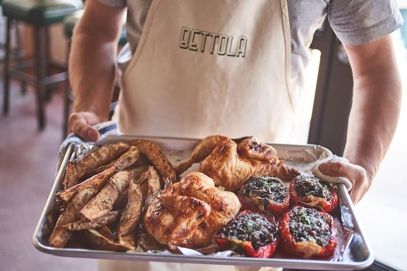 Twice-cooked potatoes, rotisserie chicken, and stuffed peppers from Bettola’s menu of Italian comfort food. Photo: Bureau Jules.