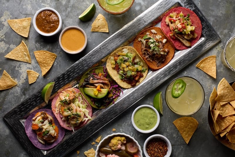 Six rainbow-colored tacos for Taco Tuesdays during PRIDE month at Merkado. Photo courtesy of Merkado.