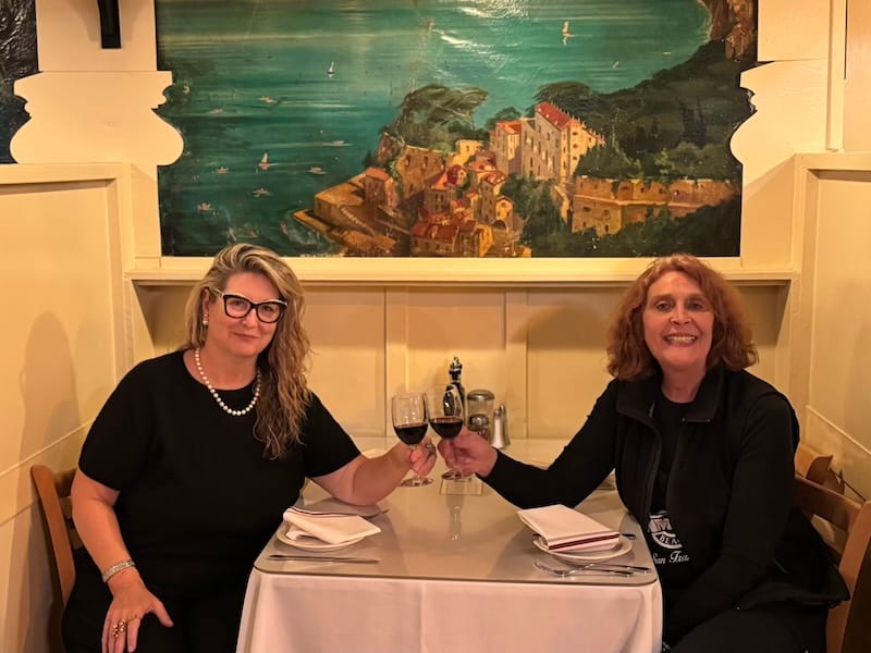 Cin-cin to a successful passing of the torch: incoming owner Mo Donegan and current co-owner Carmen Crotti. Photo courtesy of Mo Donegan.