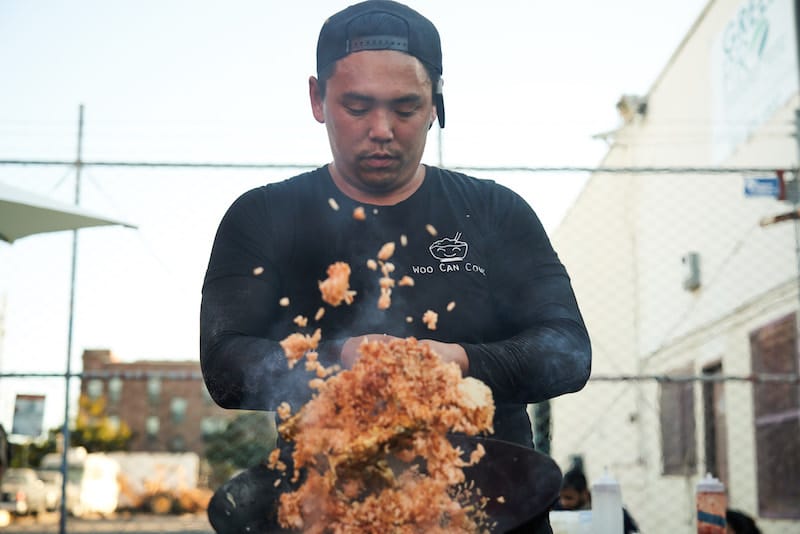 Wesley Woo tosses fried rice for Woo Can Cook. Photo: ⓒ Don Feria.
