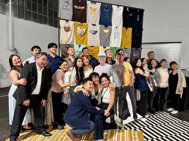 The Phan family and Slanted Door Group in front of the step-and-repeat made of Charles’s t-shirts, with life-sized cut-outs of Charles you could pose with (and hug). Photo: © tablehopper.com.