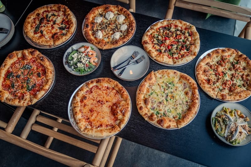 An array of pies you can try from Cheezy’s Artisan Pizza. Photo: Charles Walter.