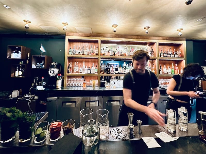 The bar is lined with fresh garnishes. Photo: © tablehopper.com.