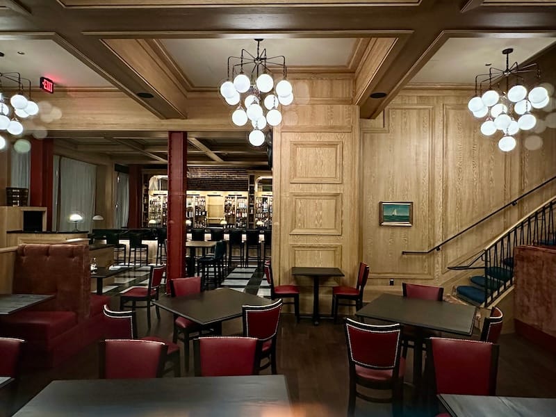 A look into the main dining room, with oak paneled walls and high-backed booths. Photo: © tablehopper.com.