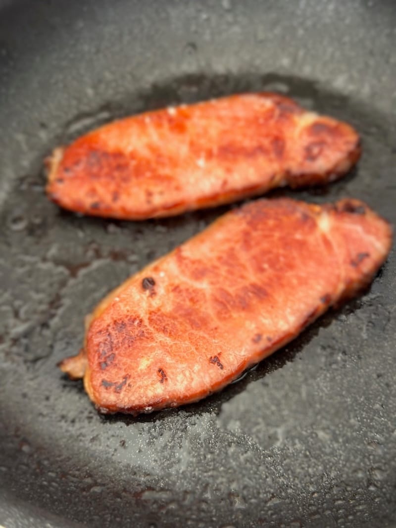Browning up Early to Rise’s Canadian bacon at home. Photo: © tablehopper.com.