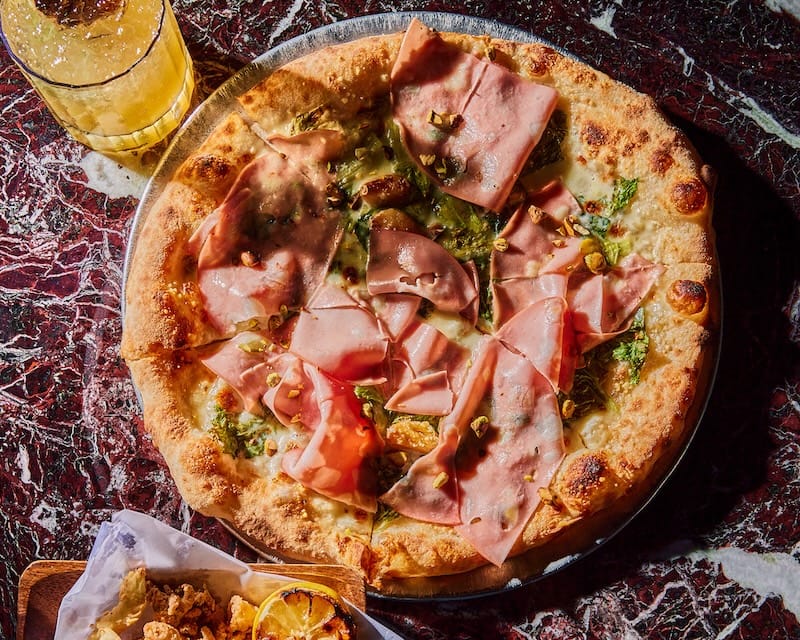 The mortadella pizza with stracchino, pistachio, escarole, and garlic. Photo: Michelle Min.