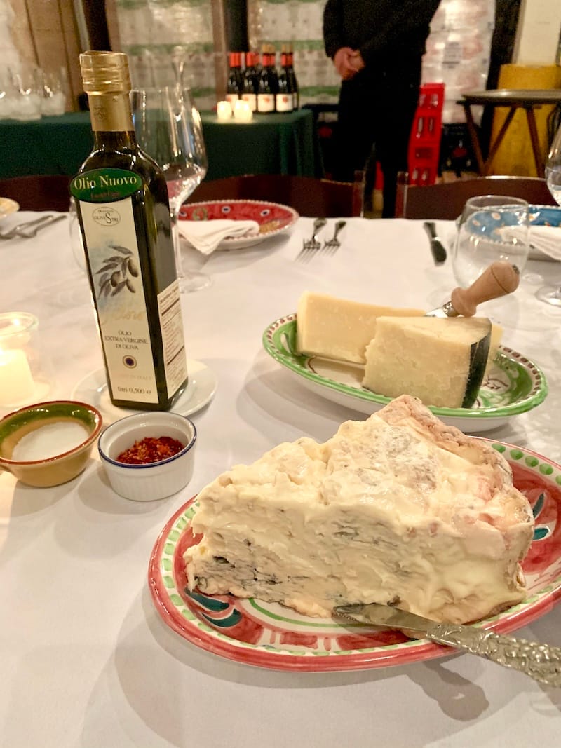 A huge slice of Gorgonzola and a fresh bottle of olio nuovo at a Casa de Case Cena nel Magazzino. Photo: © tablehopper.com.