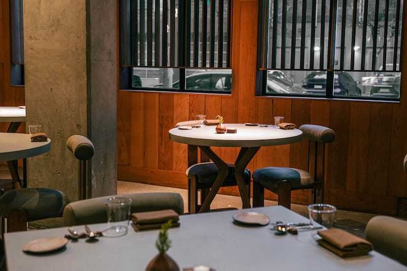 The custom concrete-topped tables in the dining room at the new Sons & Daughters in the Mission. Photo: Tina Yang.