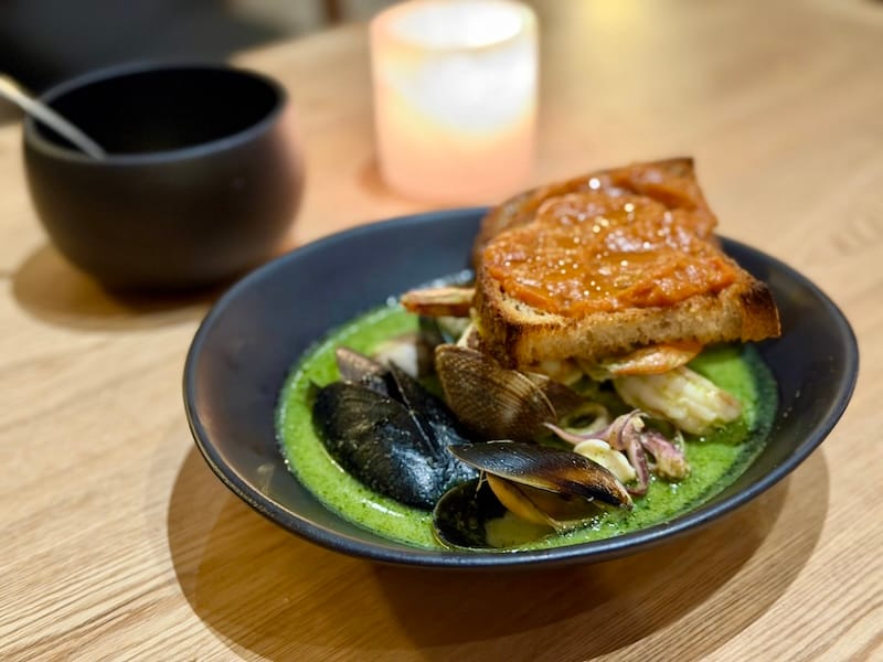 Chef Melissa Perfit’s trademark green cioppino. Photo: © tablehopper.com.