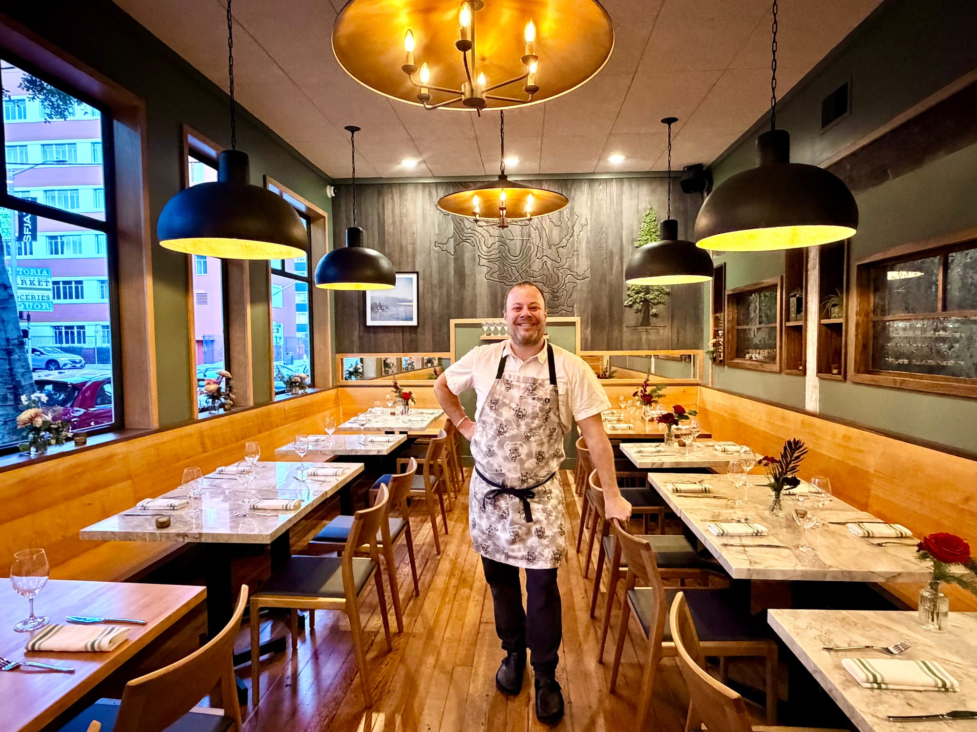 Chef Evan Rich with the topographical map of Kirkwood behind him in RT Bistro’s dining room. Photo: © tablehopper.com.