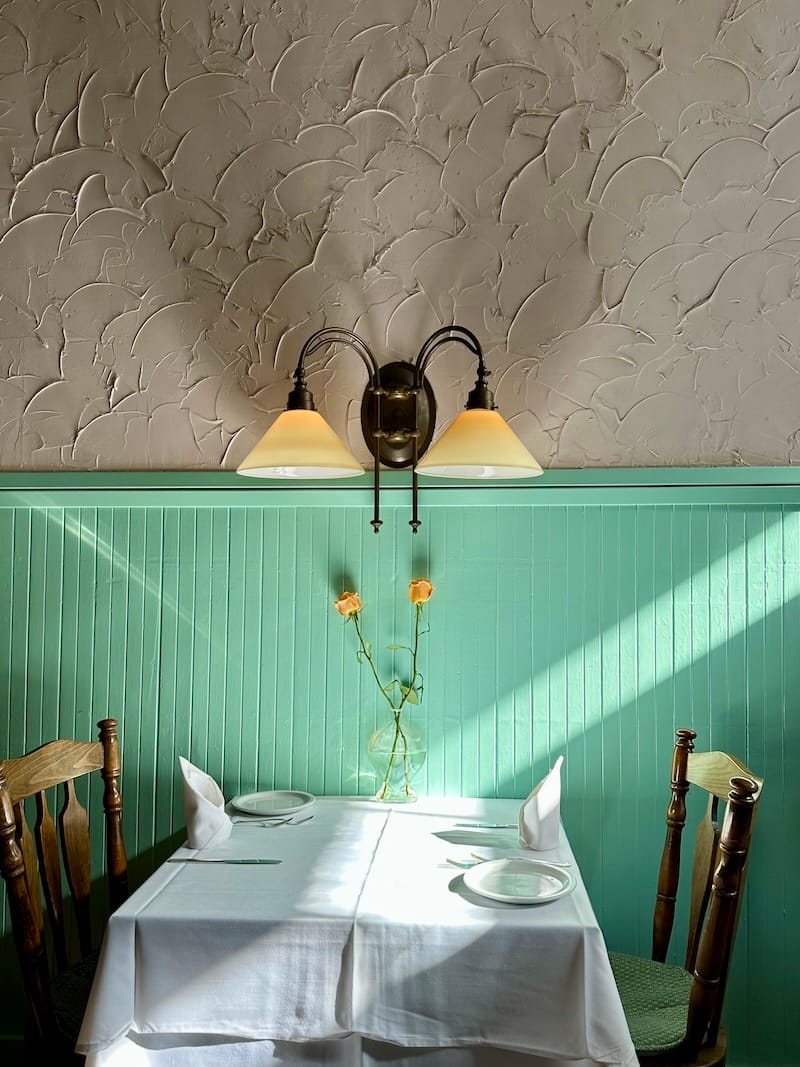 The last rays of evening light on a table at Cafe Jacqueline. Photo: © tablehopper.com.