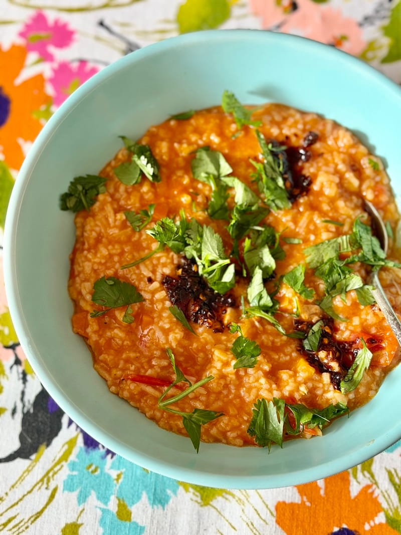 Are you sick, too? I wish this had Smell-O-Vision for you! I added carrots, cilantro, and plenty of chile crisp to this ginger-tomato chicken and rice soup. Photo: © tablehopper.com.
