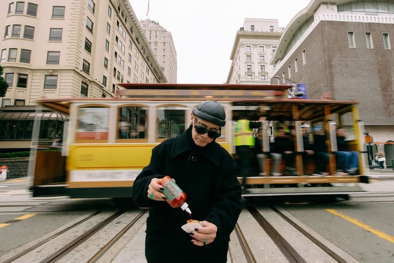 SF fashion icon Calvin Hom taking DOU’s sriracha to the streets! Photo: Megan Goetz.