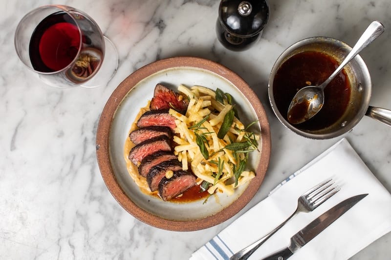 A classic at Delfina: hanger steak and fries. Photo courtesy of Delfina.