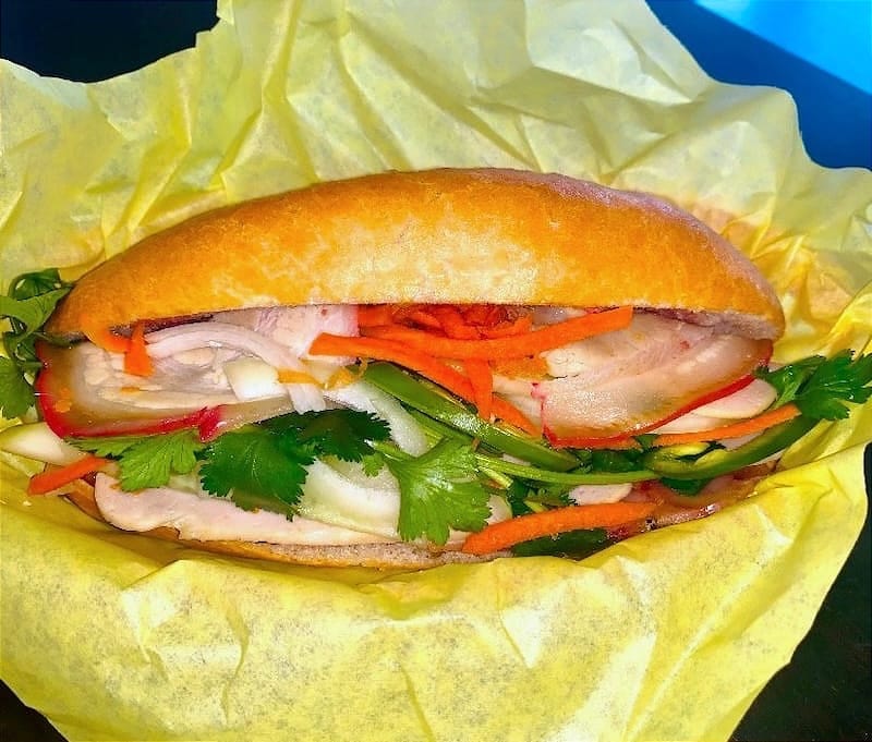 The pork combo from Sing Sing Coffee Shop is back: pork belly, head cheese, and chả lụa (pork sausage) with aioli, pâté, cucumber, pickled carrots, cilantro, jalapeño. For just $8! Photo: Banh Mi A Mui.