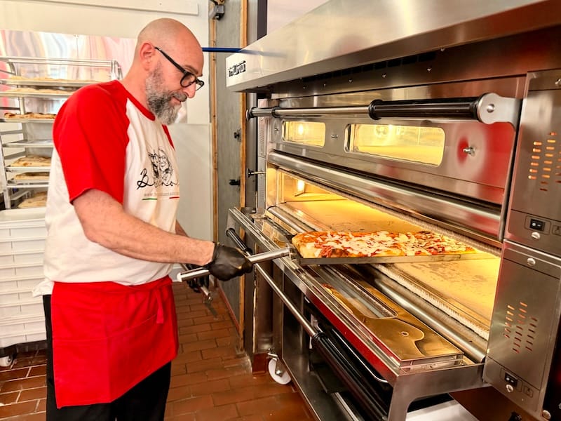 Fabio doing his pizza magic at his new deck oven. Photo: © tablehopper.com.