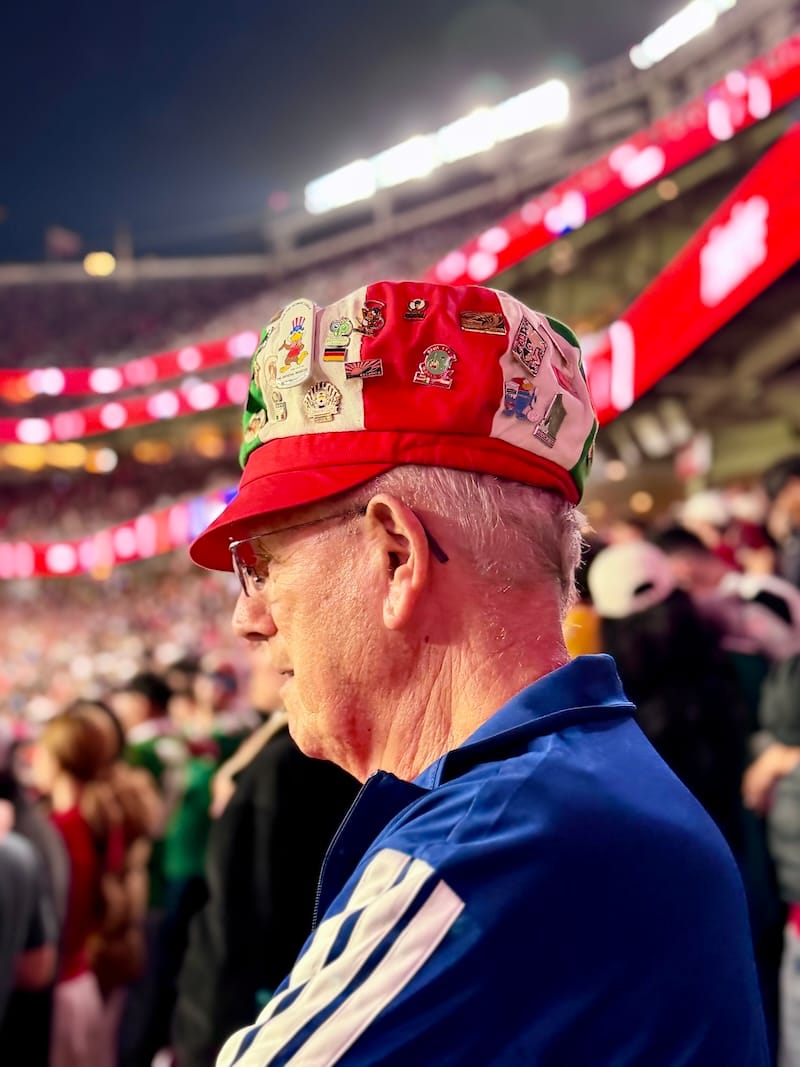 Carm’s iconic hat features his collection of pins from eight World Cups. Photo: © tablehopper.com.