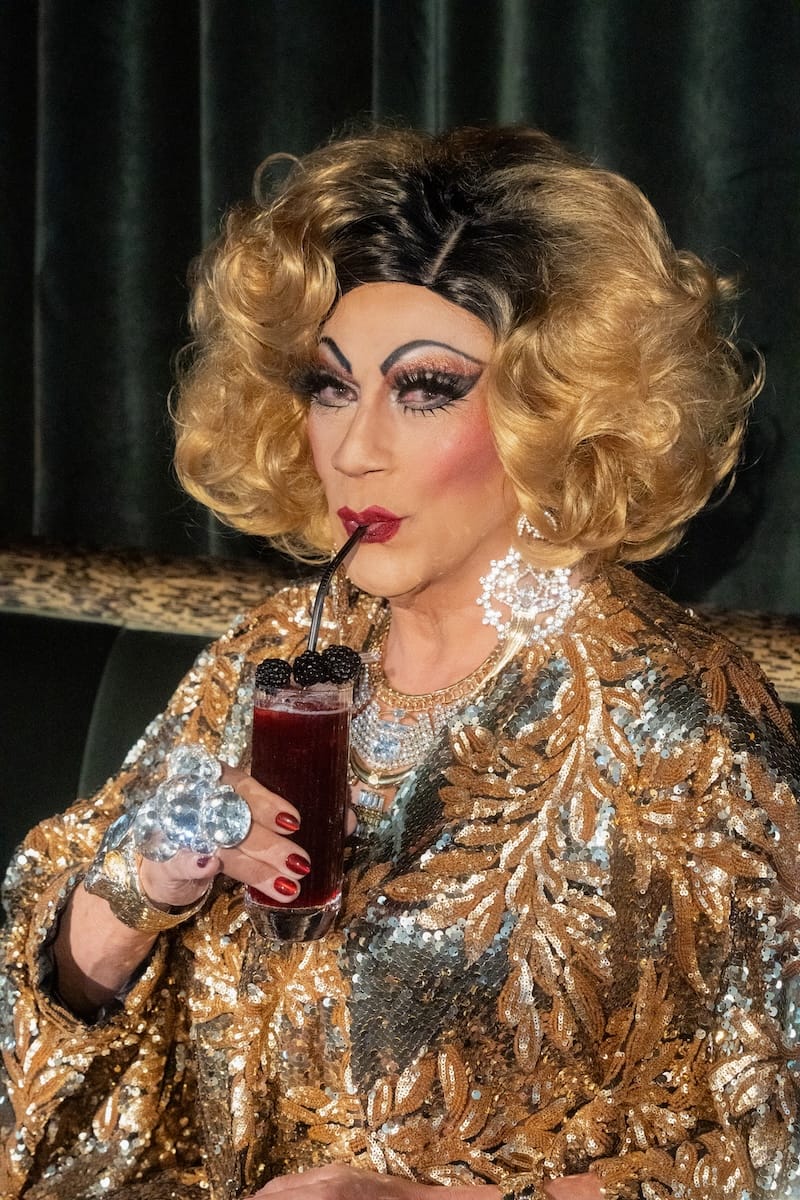 Juanita MORE! taking a sip of her namesake Pride cocktail for FLOOR21 at Starlite. Photography by Starr Gazers.