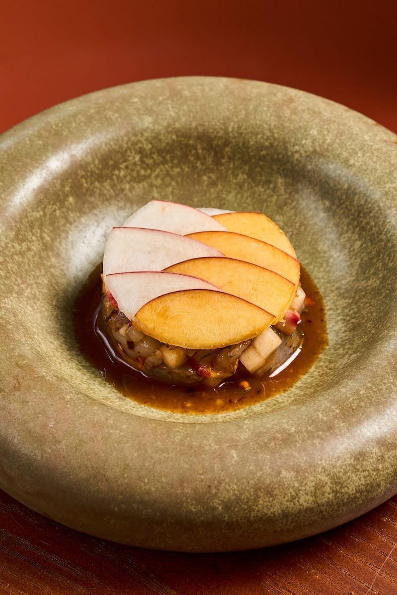 Som tum peach (marinated shrimp, peach, cherry tomato, fermented fish sauce). Photo courtesy of SAAM.