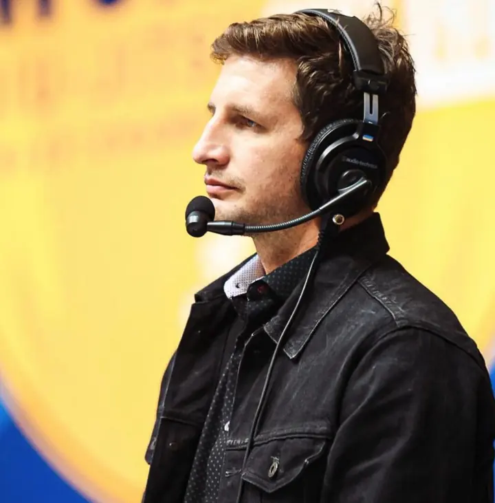 Chase Smith wearing a broadcast headset at a jiu-jitsu event