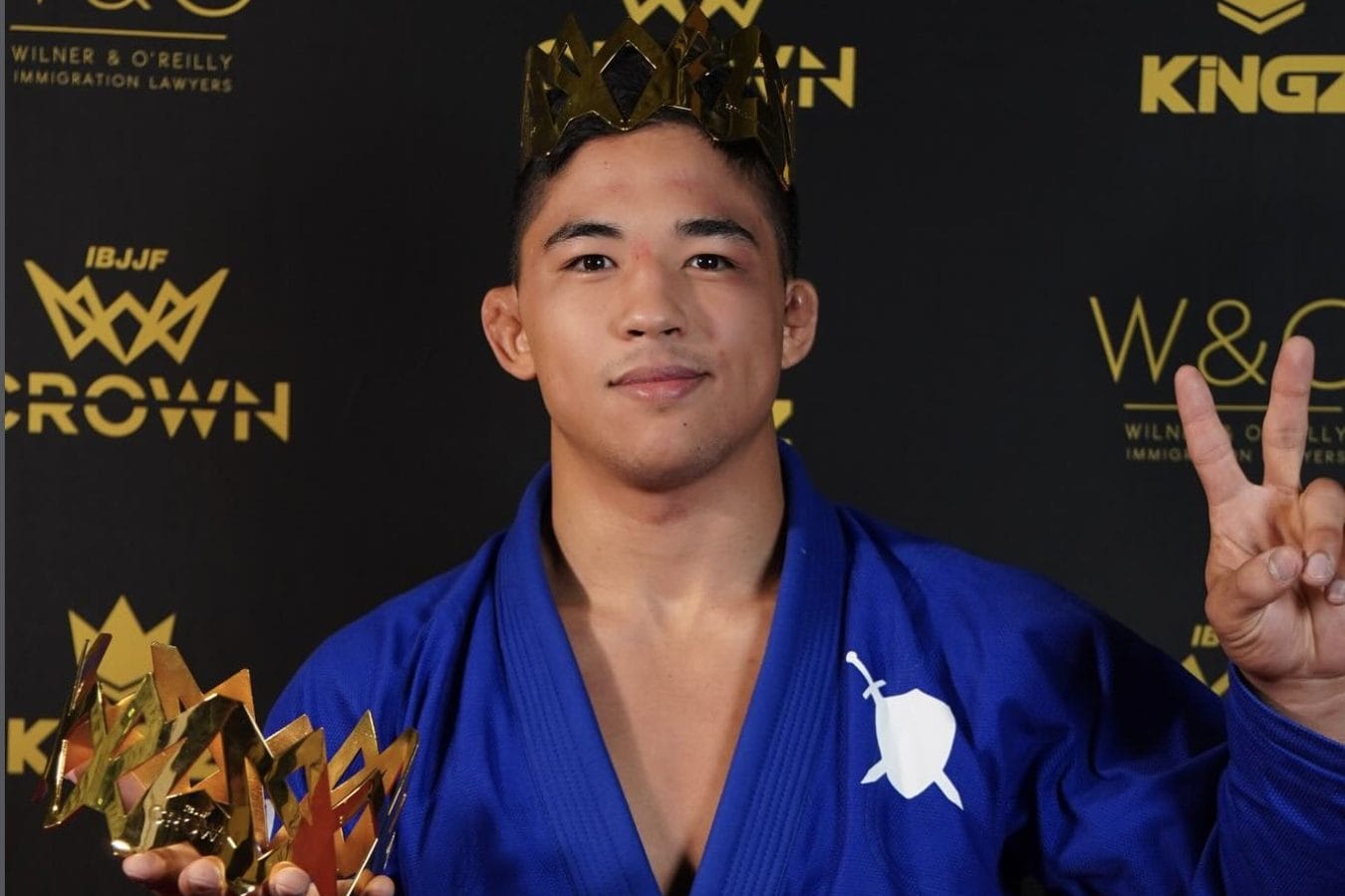 Andy Murasaki holds up the Crown trophy