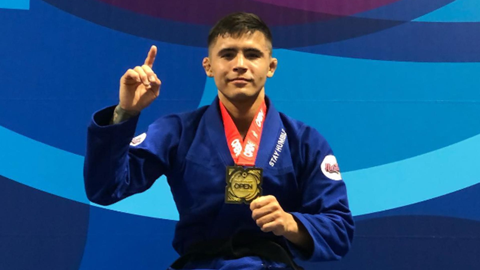 Sam Nagai on the podium with a gold medal