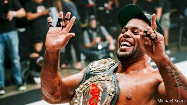 André Galvão celebrates with a championship belt