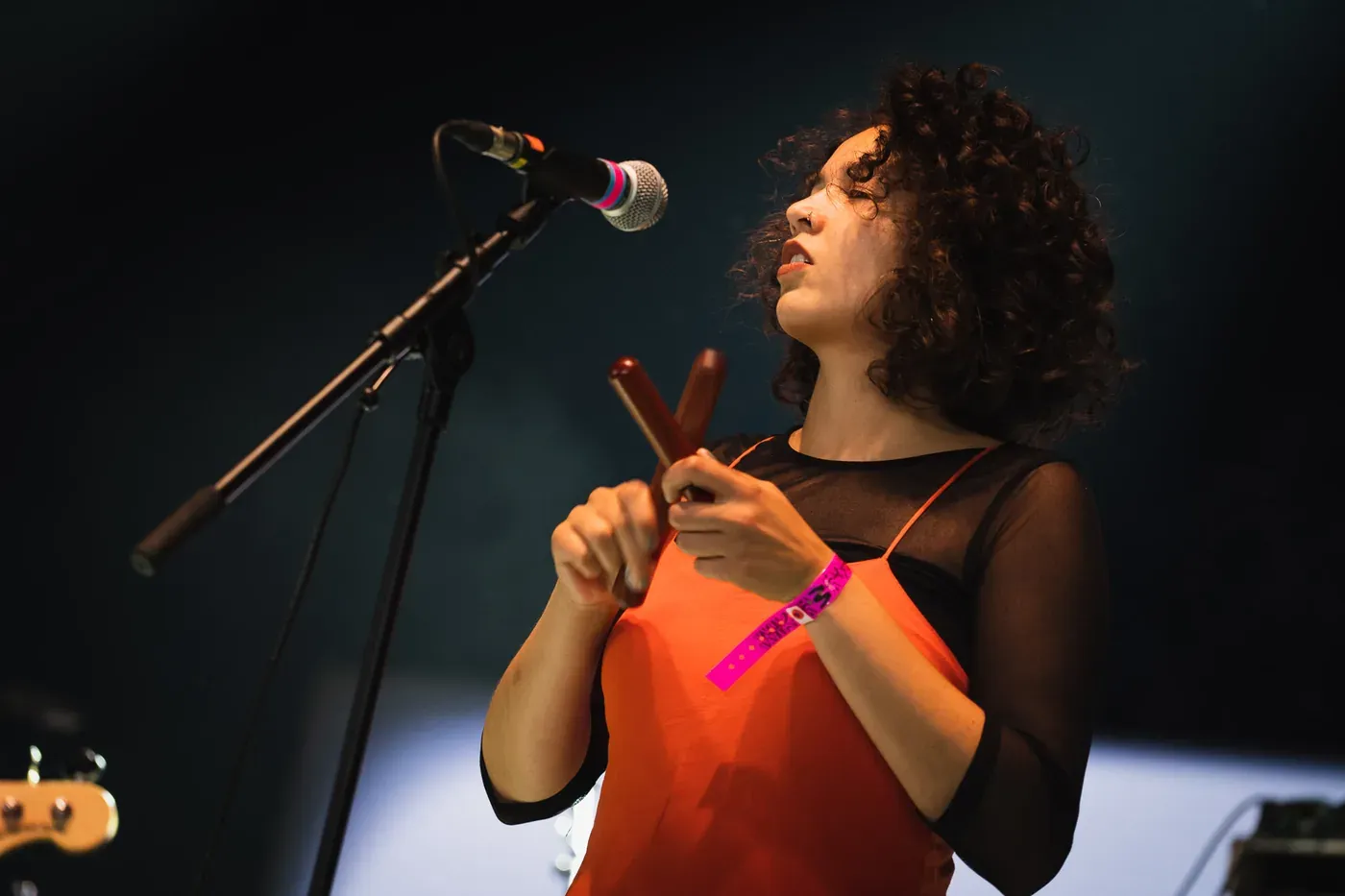 A Certain Ratio's singer performing with a microphone and percussion at Wide Awake Festival