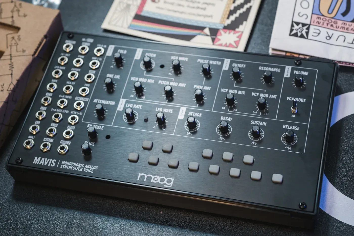 Assembled Moog Mavis semi-modular synth with its patch points, knobs and keypad buttons on a desk