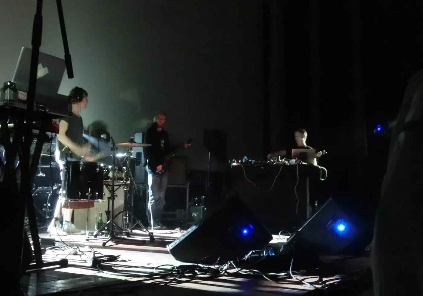 Michael Rother and band performing Neu! and Harmonia music on a dark stage in St Petersburg