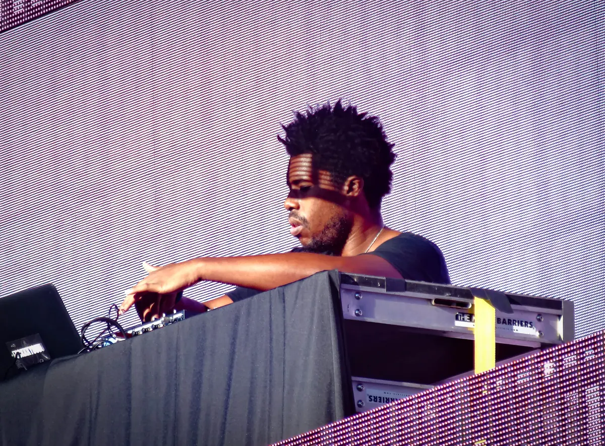 Flying Lotus performing behind his equipment on stage at ACL Music Festival