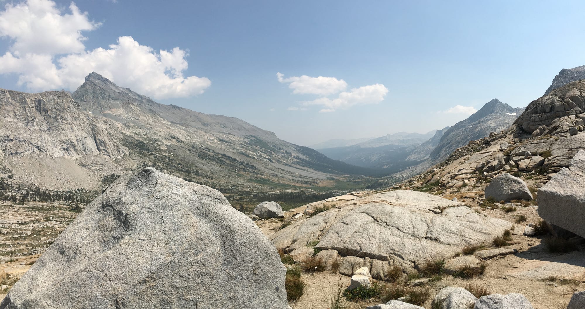 A sweeping view of a valley tucked between the granite mountains of the Sierra Nevada