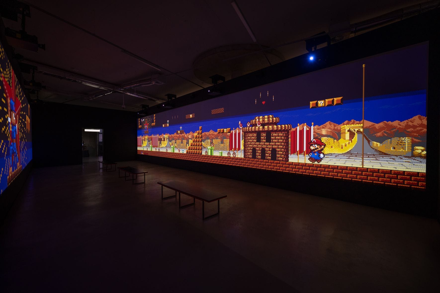 A long interactive projection of a retro side-scrolling game in a museum gallery