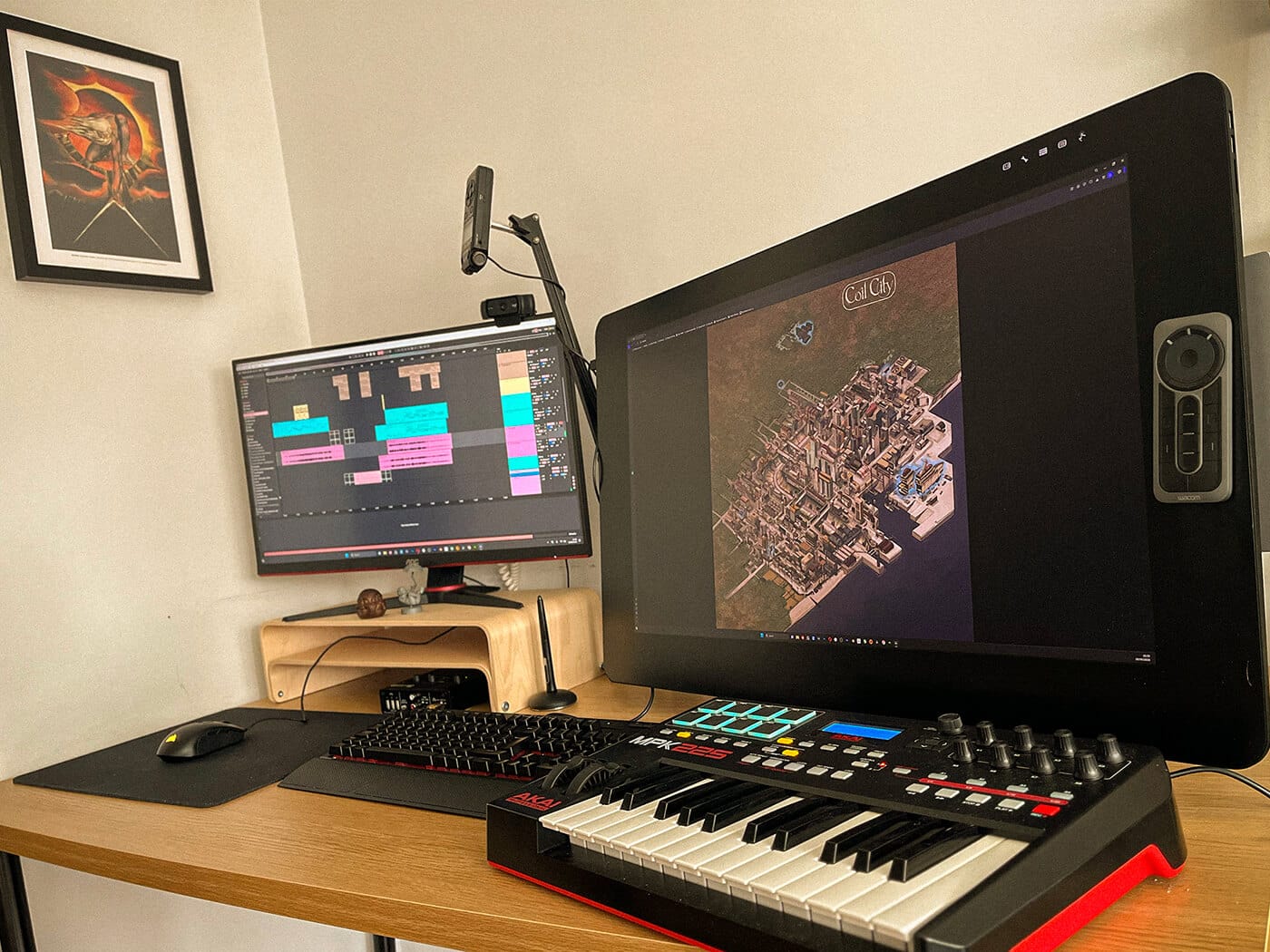 Murlo's desk with an Akai MIDI keyboard, a Wacom Cintiq and a monitor running Ableton