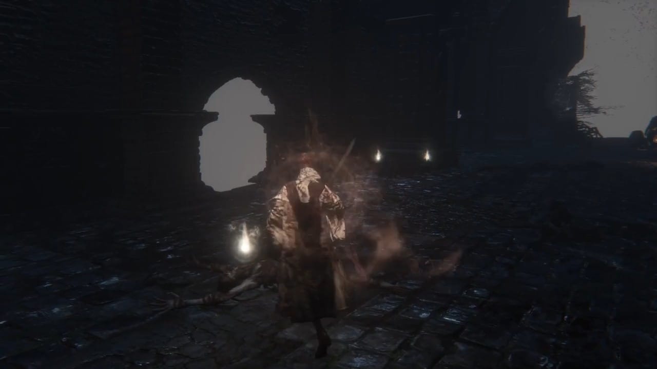 A lone cloaked figure stands in a dark stone courtyard surrounded by sparks, in a still from A bronze anvil falls to the earth.