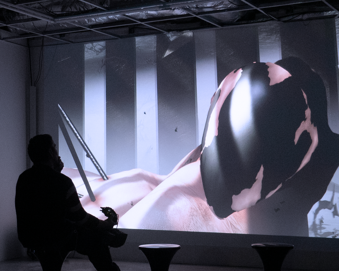 A player holds Aggregate’s custom controller in front of a large projection