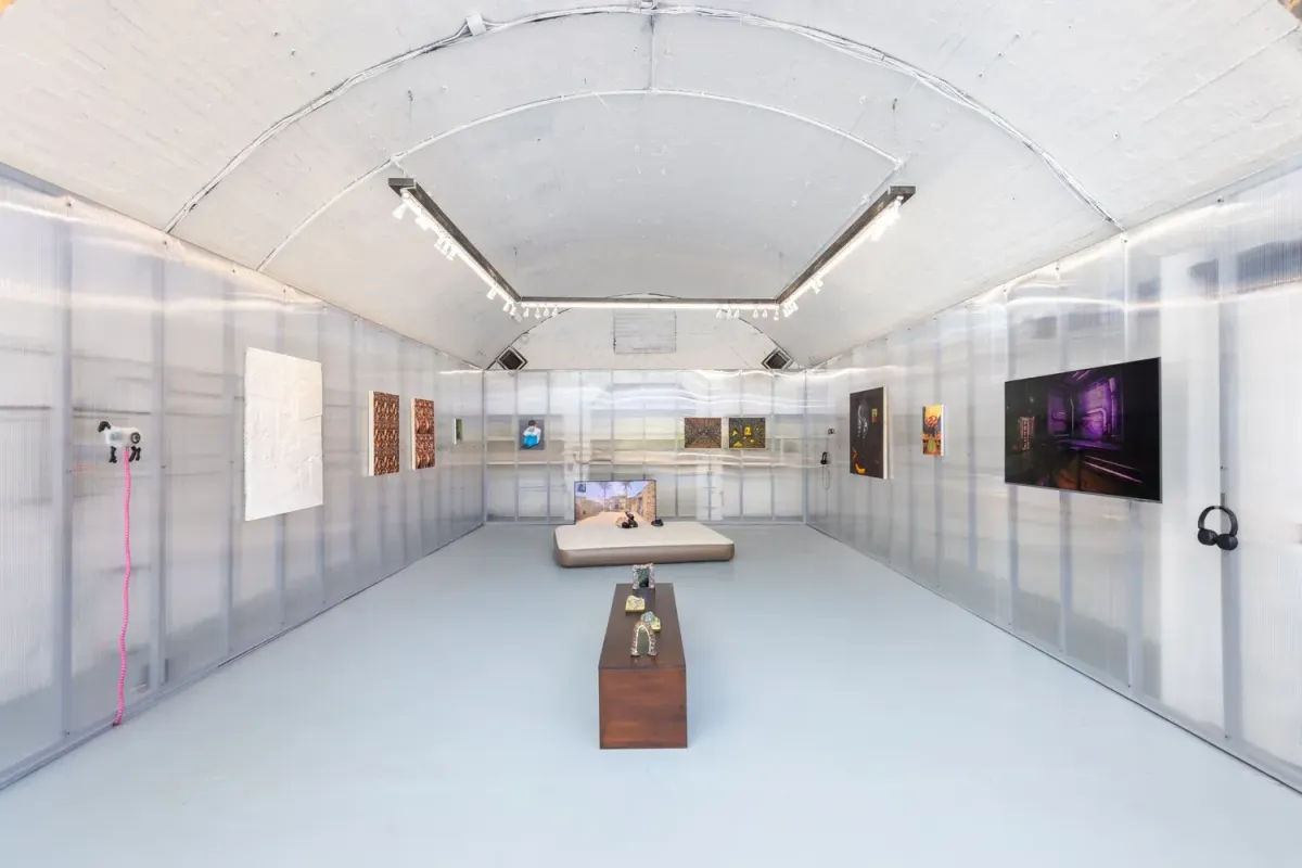 Installation view of CONTROL with game-inspired paintings in a raw gallery space