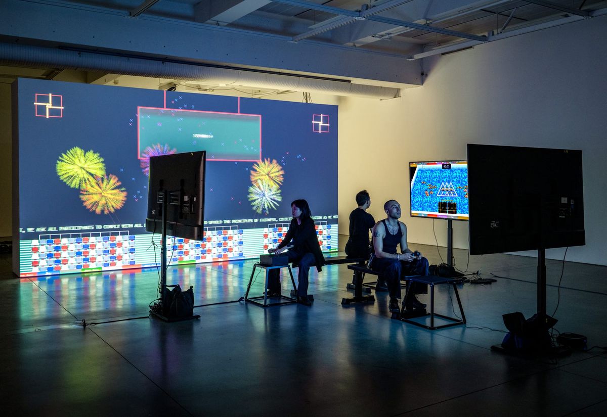Arcade cabinet installation of Qilinic Games glowing in a darkened gallery