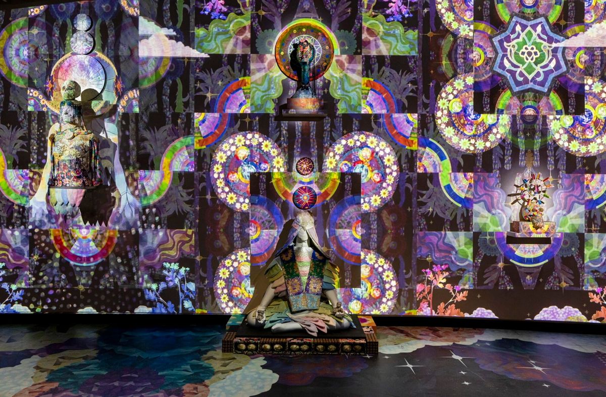 Kaleidoscopic projection with a human silhouette at its center, from Saya Woolfalk's Floating World of the Cloud Quilt
