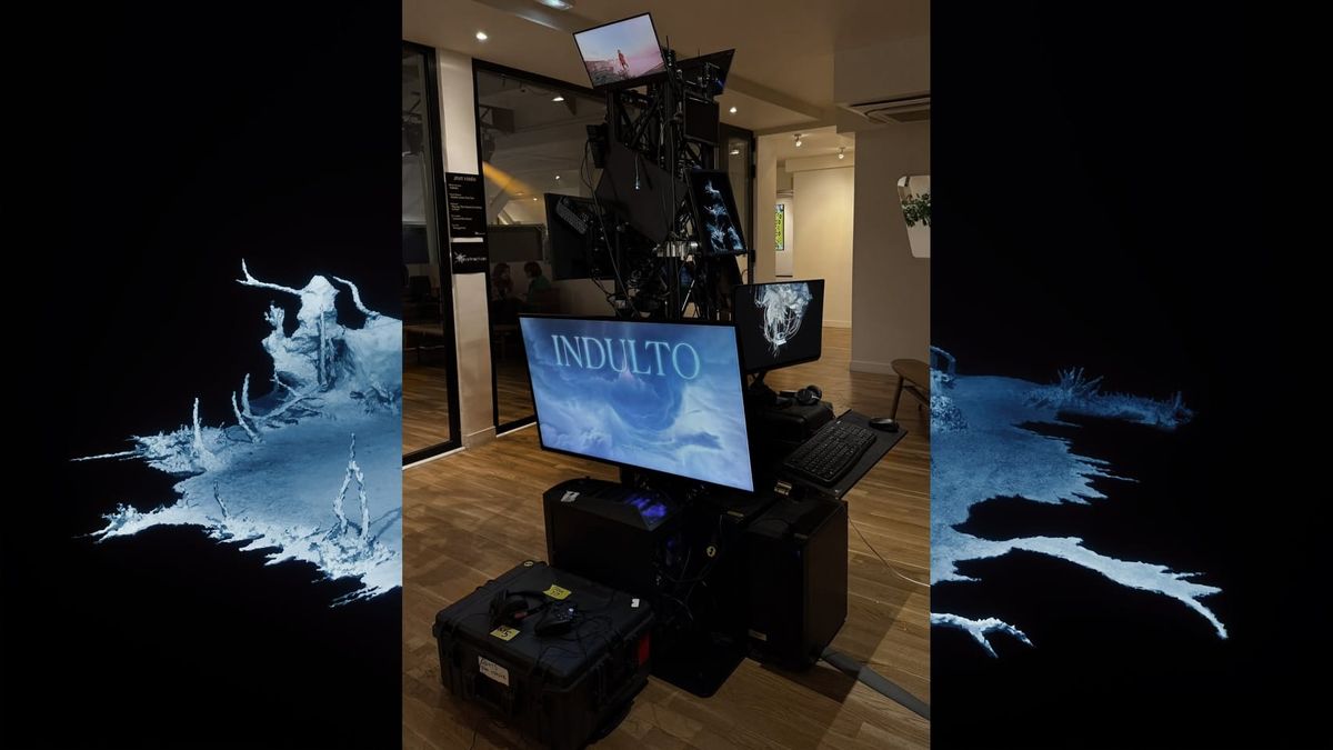A stacked tower of screens and road cases displays video games inside a gallery space.
