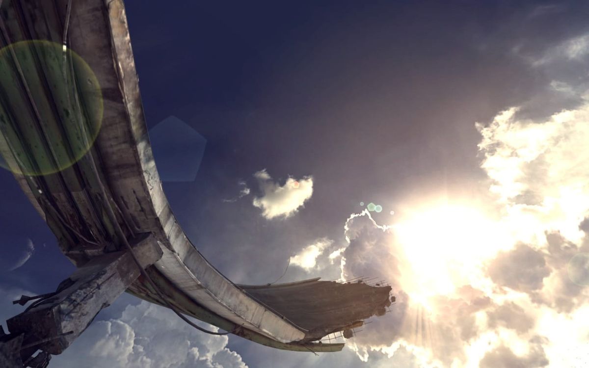 A vast concrete structure curves overhead against a bright cloudy sky, photographed inside the game Rage.