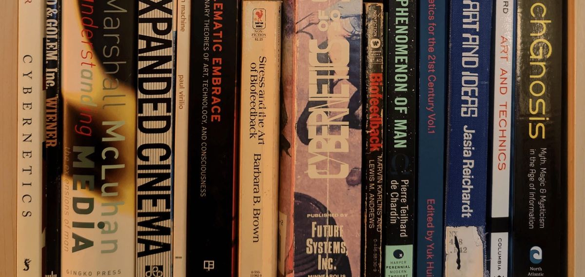 A close row of worn book spines on a library shelf.