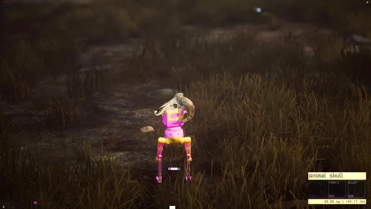 A small robot glowing pink stands in a dark field of tall grass