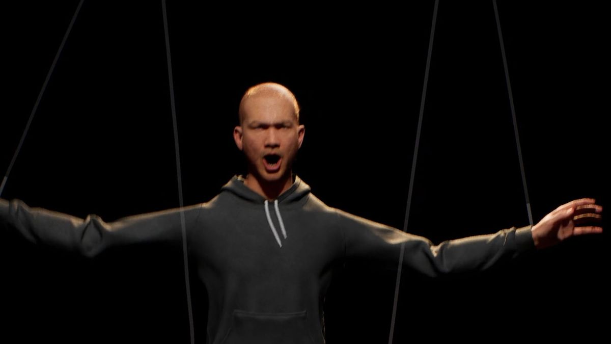 A 3D figure in a black hoodie hangs from marionette strings, arms outstretched, in the installation PUPPET
