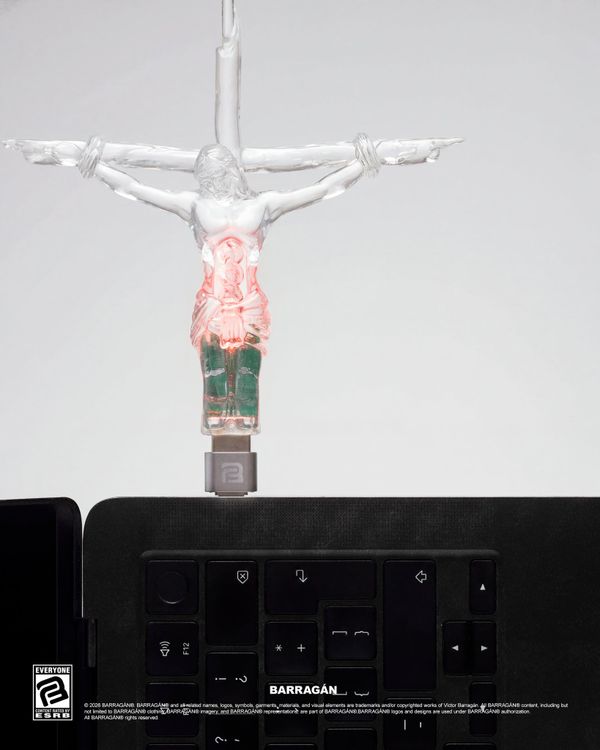 A plastic crucifix USB drive on a curb chain necklace