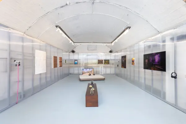 Installation view of CONTROL with game-inspired paintings in a raw gallery space
