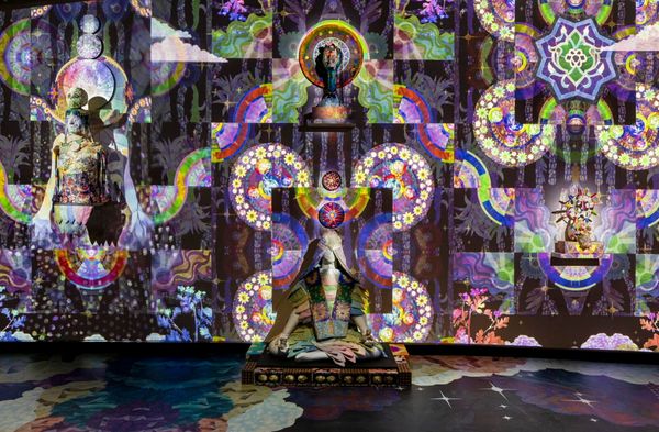 Kaleidoscopic projection with a human silhouette at its center, from Saya Woolfalk's Floating World of the Cloud Quilt