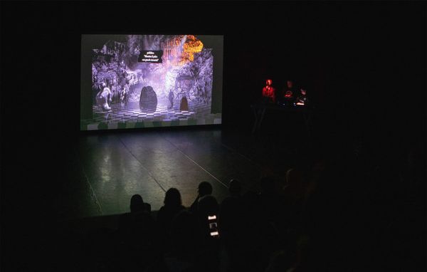 A performance of Waluigi’s Purgatory by dmstfctn, with a 3D theatre projected above a stage