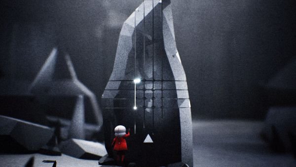 A small figure in red stands before a towering carved monolith marked with glowing symbols