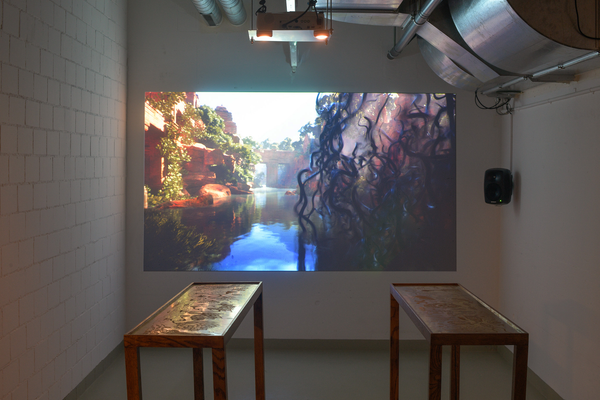 Atithi installed in a basement room at Basel Social Club 2026: two brass plates on stands before a projected simulation